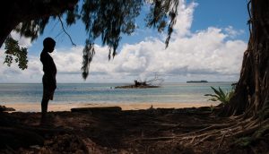 Silhouette of a boy on a beach in Papua New Guinea. A\J AlternativesJournal.ca 