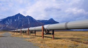 Trans-Alaska oil pipeline with mountains in the background. Alternatives Journal