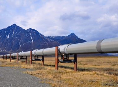 Trans-Alaska oil pipeline with mountains in the background. Alternatives Journal