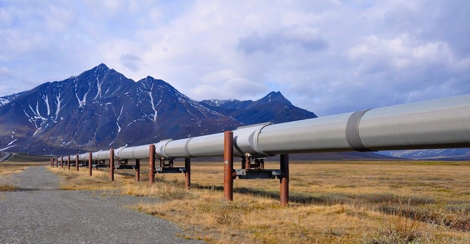 Trans-Alaska oil pipeline with mountains in the background. Alternatives Journal