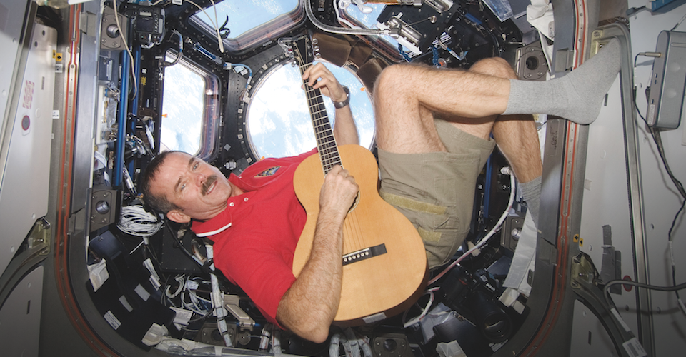 Colonel Chris Hadfield playing guitar in the International Space Station.