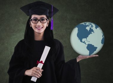 Graduating student holds the planet in her hands.