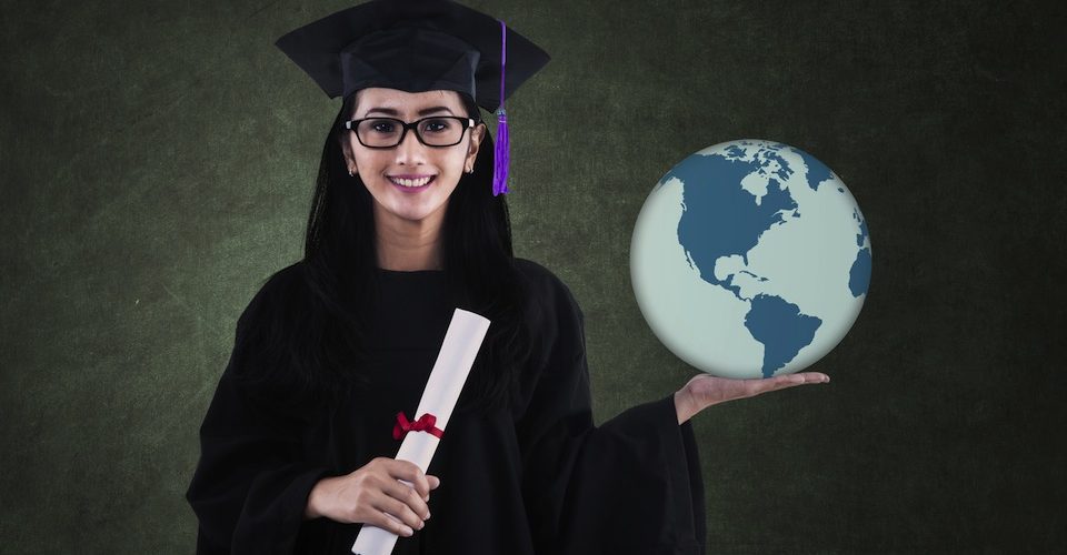 Graduating student holds the planet in her hands.