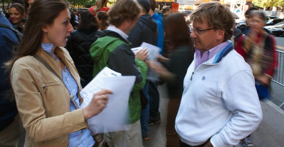 Woman and man having a conversation on the street.