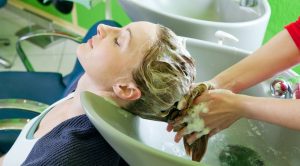 Woman getting her hair washed in a salon.