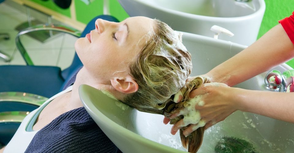 Woman getting her hair washed in a salon.