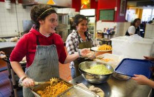 Volunteers serve food at St. John's Kitchen.