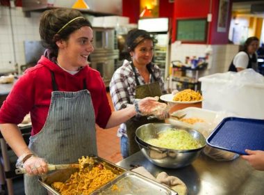 Volunteers serve food at St. John's Kitchen.