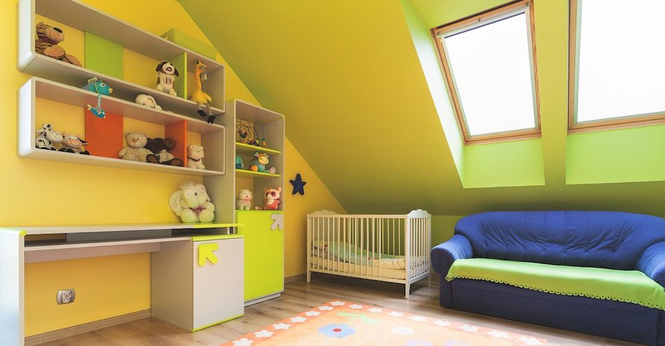 Nursery with shelves, a crib, couch and skylights.