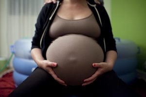 Pregnant woman in front of a birthing pool.