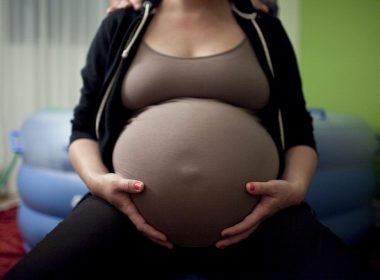 Pregnant woman in front of a birthing pool.