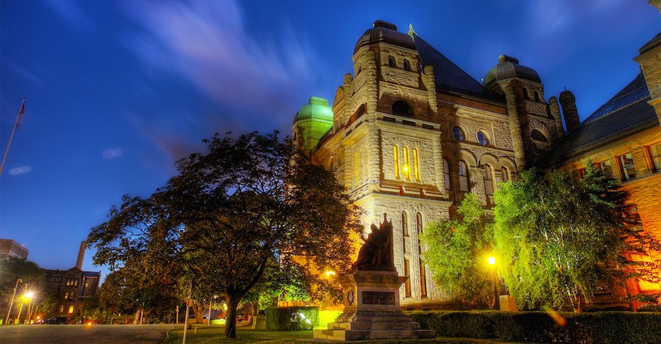 Queen's Park, Ontario parliament building at night.