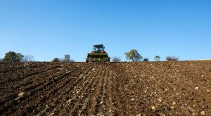 Tractor sowing seeds on a field.