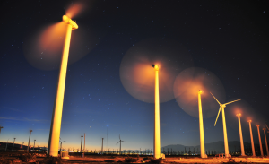 Windfarm with blades moving at sunrise