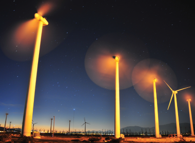 Windfarm with blades moving at sunrise