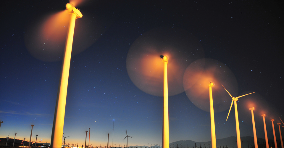 Windfarm with blades moving at sunrise