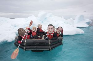 Activists in papier-mâché world leaders' heads flounder in the Arctic Ocean.