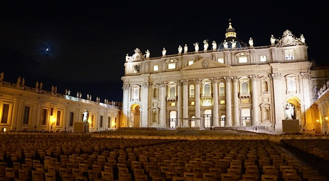 St Peter's Basilica at night with empty chairs.