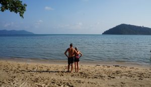 (Photo: a couple stands on a beach in Thailand)