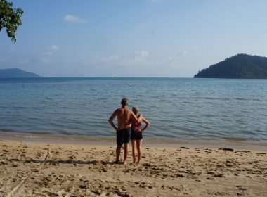 (Photo: a couple stands on a beach in Thailand)