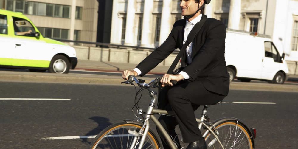 (Photo: a businessman riding a bicycle to work)